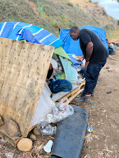 Shane O’Garro visiting an encampment during homelessness outreach in San Diego